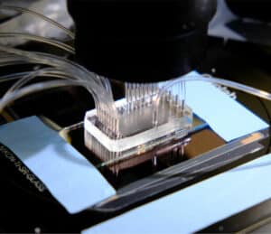 Workcell with a microfluidic chip testing thousands of AI designed proteins.